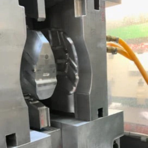 Metalworking process with a close-up of a metal component being shaped.