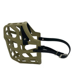 The Muzzle Movement Khaki Taz dog muzzle with black straps and chicago screws on a white background