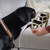 The Muzzle Movement Neli muzzle in khaki with pastel purple biothane strapping on a black Labrador 