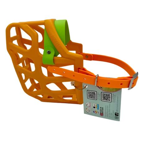 The Muzzle Movement Orange Taz* dog muzzle with apple green noseband and peach straps with nickle hardware on a white background