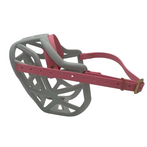 The Muzzle Movement grey Harry 2.0 dog muzzle with pastel pink straps and brass hardware on a white background