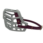 The Muzzle Movement grey Tolly dog muzzle with wine straps and brass hardware on a white background
