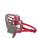 The Muzzle Movement pastel pink Neli* dog muzzle with neon pink straps and black hardware on a white background