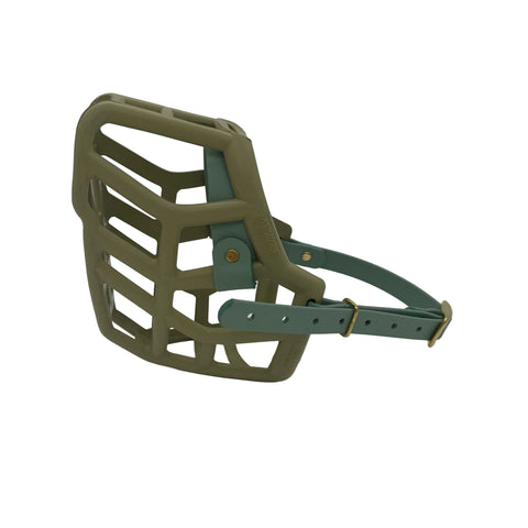 The Muzzle Movement khaki green dog muzzle with sage straps on a white background